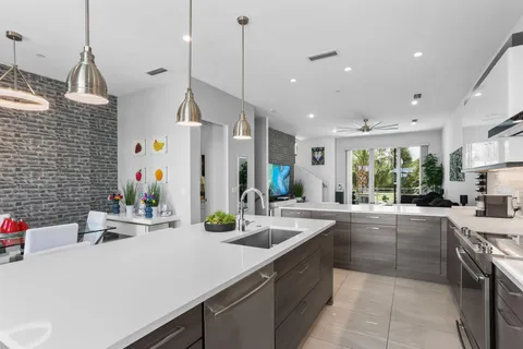 a living room with stainless steel appliances kitchen island granite countertop furniture and a view of kitchen