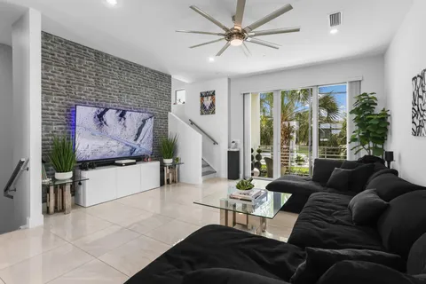 a living room with stainless steel appliances kitchen island granite countertop furniture and a view of kitchen