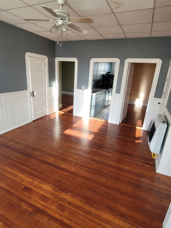 303 Cambridge Street, Unit 3 Fall River, MA 02721 - Photo 5 of 9 a view of a livingroom with wooden floor and an empty space