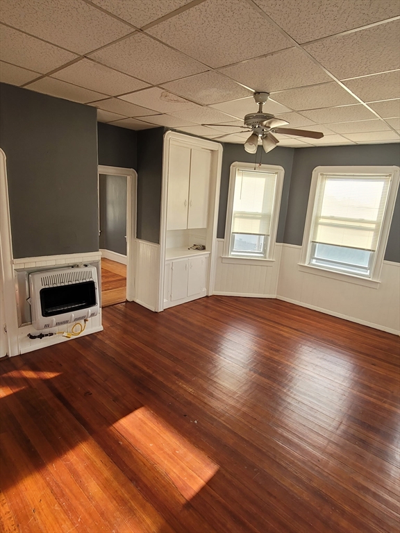 303 Cambridge Street, Unit 3 Fall River, MA 02721 - Photo 6 of 9 a view of an empty room with wooden floor and a window