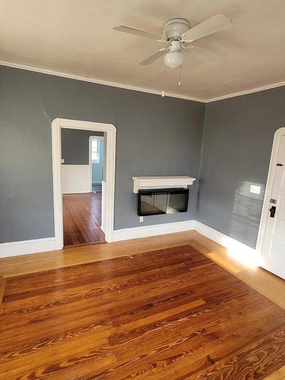 303 Cambridge Street, Unit 3 Fall River, MA 02721 - Photo 9 of 9 a view of empty room with wooden floor and fan