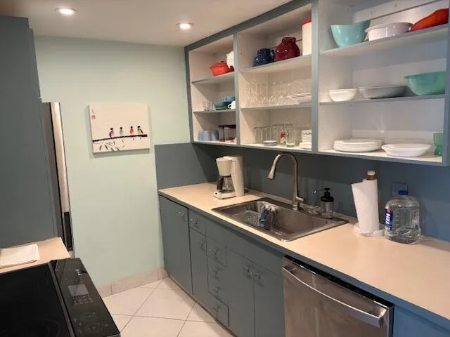 a kitchen with a sink and refrigerator