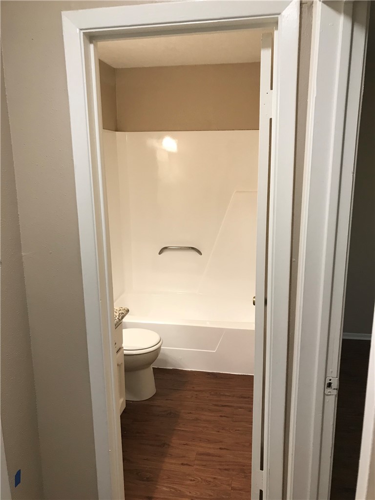 3203 Cougar Trail, Unit A Bryan, TX 77807 - Photo 11 of 15 a bathroom with a granite countertop toilet and a sink