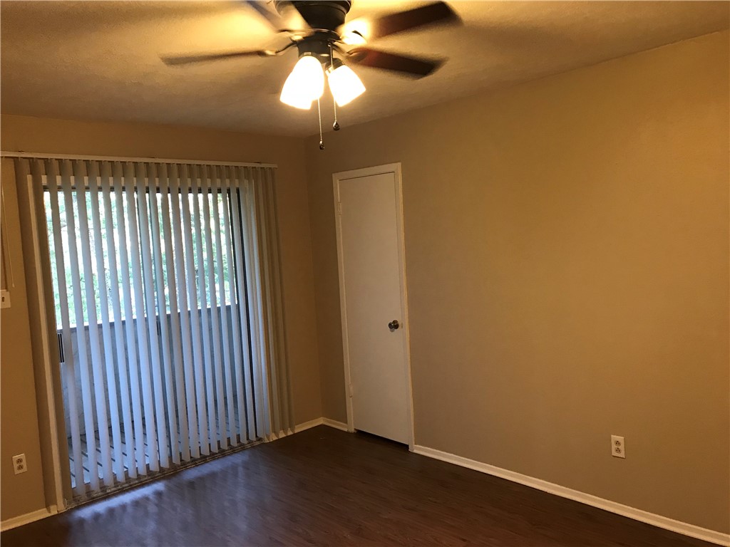 3203 Cougar Trail, Unit A Bryan, TX 77807 - Photo 14 of 15 an empty room with wooden floor fan and windows