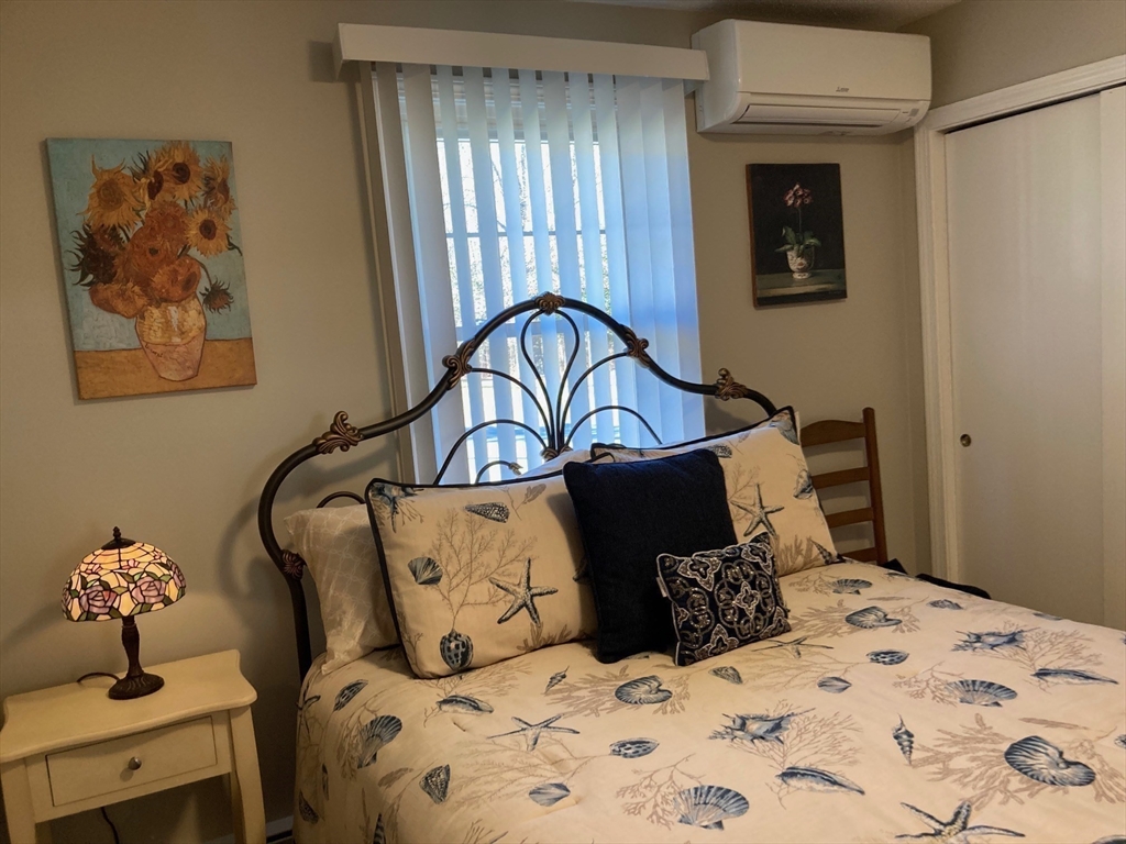 17 Brookside Drive Acushnet, MA 02743 - Photo 17 of 41 a bedroom with a bed and wooden floor