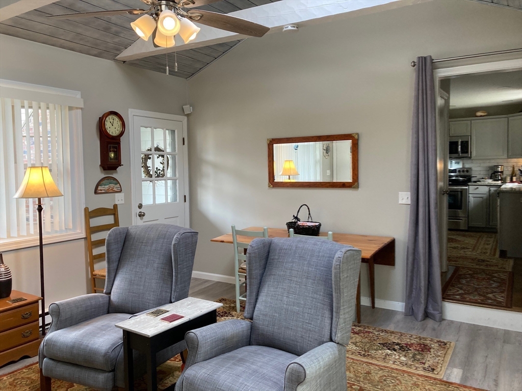 17 Brookside Drive Acushnet, MA 02743 - Photo 20 of 41 a living room with furniture a chandelier and a dining table