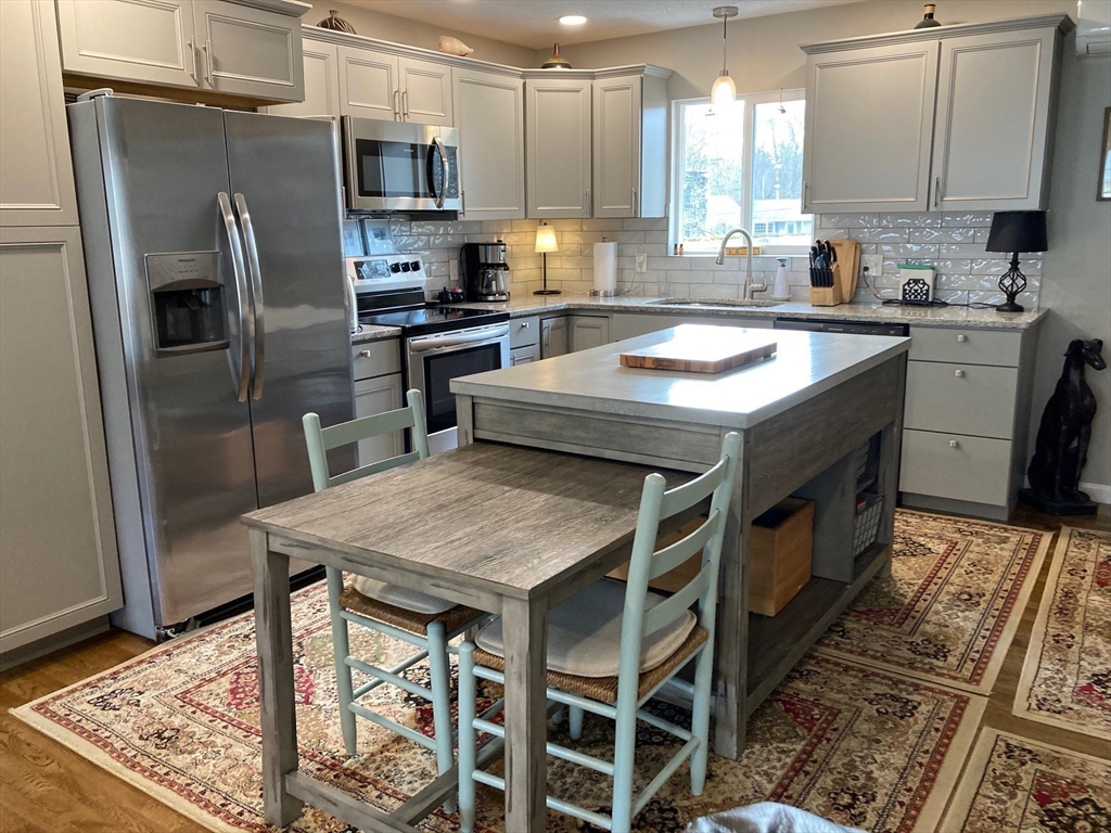 17 Brookside Drive Acushnet, MA 02743 - Photo 3 of 41 a kitchen with stainless steel appliances granite countertop a sink stove microwave and refrigerator
