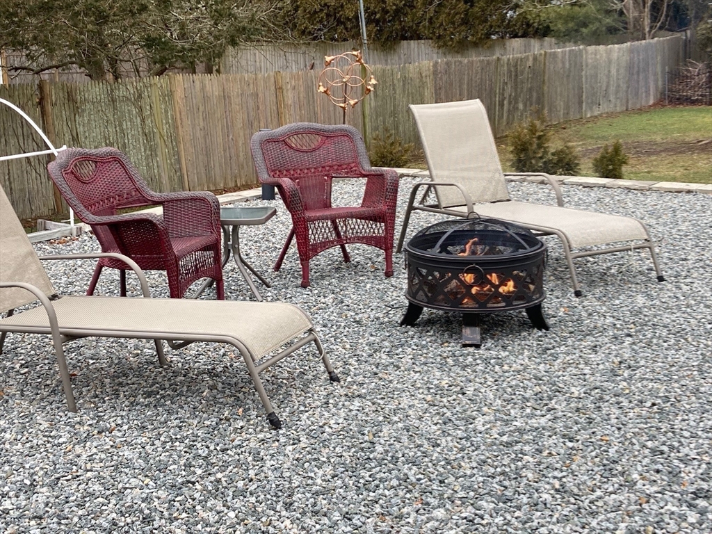 17 Brookside Drive Acushnet, MA 02743 - Photo 39 of 41 a view of a chairs and table in backyard