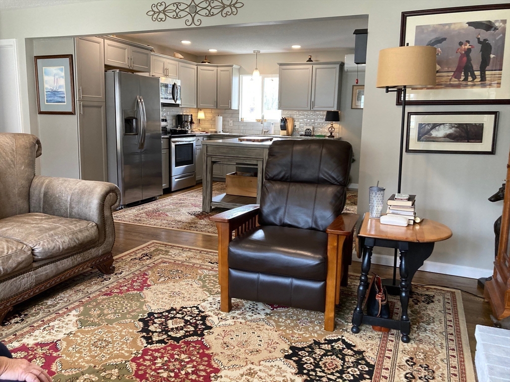17 Brookside Drive Acushnet, MA 02743 - Photo 6 of 41 a living room with stainless steel appliances kitchen island granite countertop furniture and rug