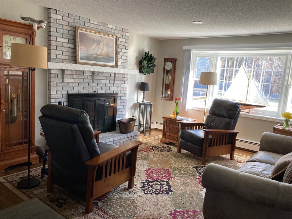 17 Brookside Drive Acushnet, MA 02743 - Photo 8 of 41 a living room with furniture and a fireplace
