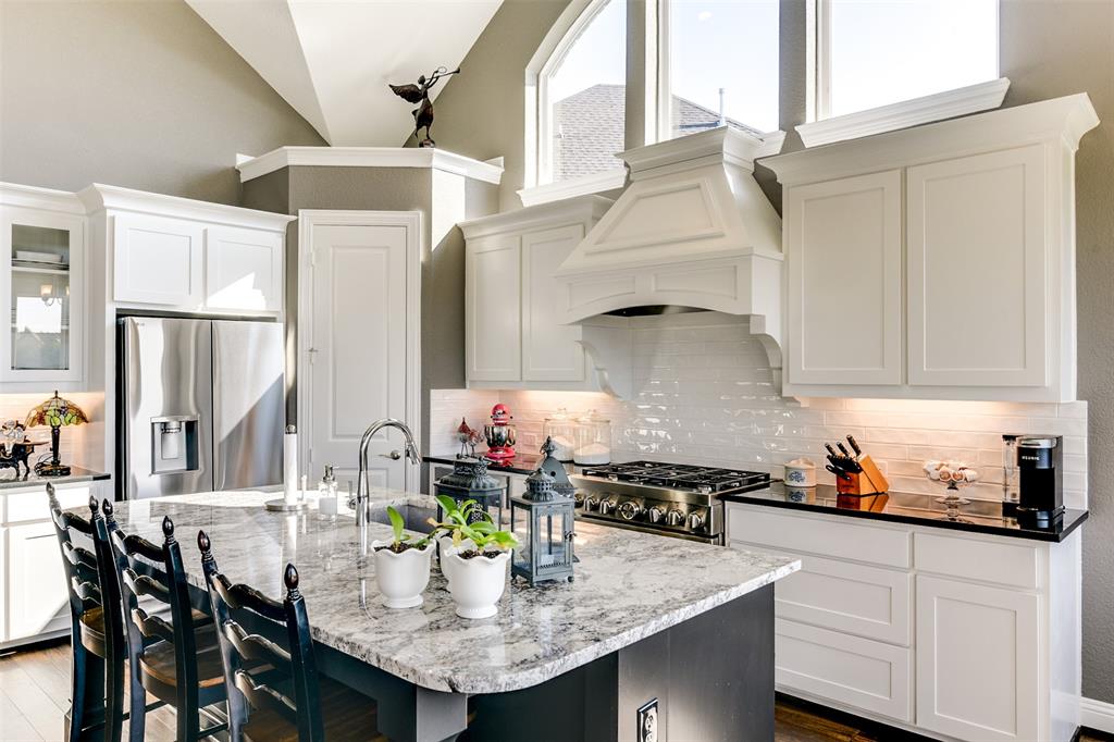 2866 Shane Drive Midlothian, TX 76065 - Photo 25 of 40 a kitchen with stainless steel appliances granite countertop a sink a stove and white cabinets