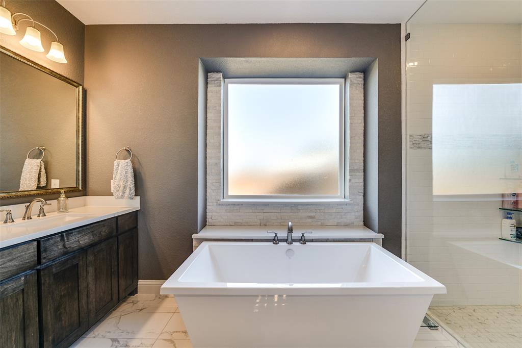 2866 Shane Drive Midlothian, TX 76065 - Photo 33 of 40 a white bath tub sitting next to a bathroom sink