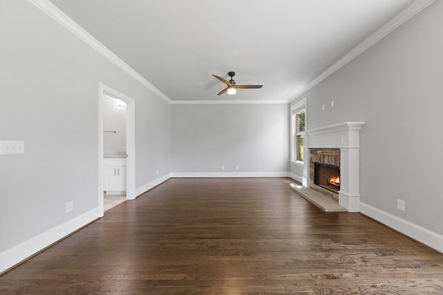 wooden floor in an empty room with a fireplace