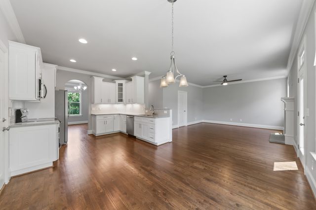 a large kitchen with a lot of counter space and stainless steel appliances