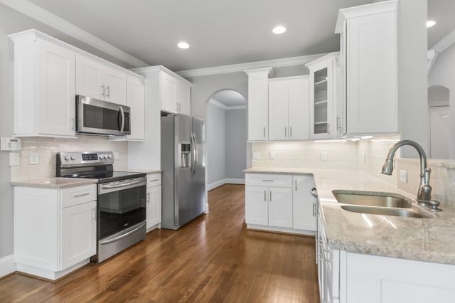 a kitchen with stainless steel appliances a refrigerator stove and microwave