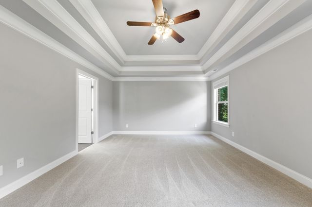 a spacious bathroom with double vanity a mirror and a shower