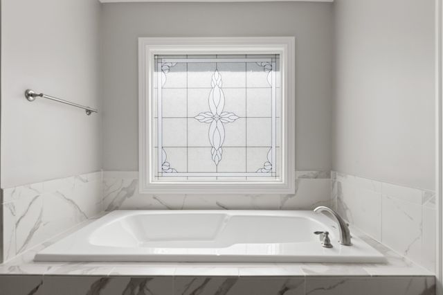 a bathroom with a glass shower door and a glass door