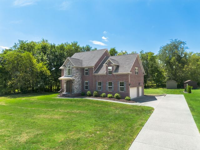 a front view of house with yard and green space