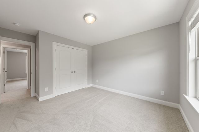an empty room with fan and windows