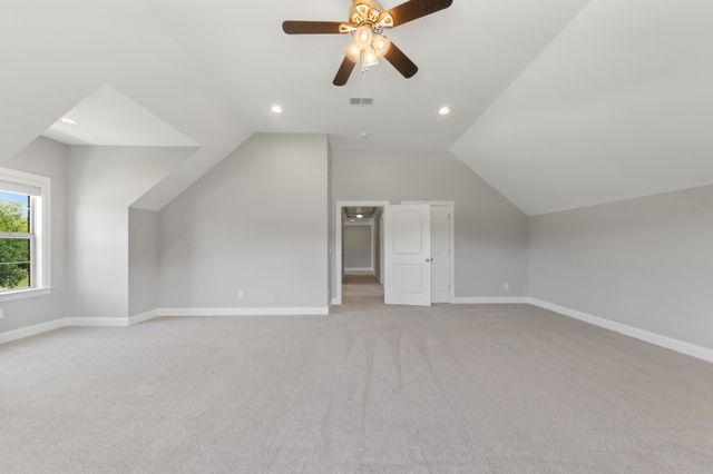 an aerial view of a house with pool a yard and lake view