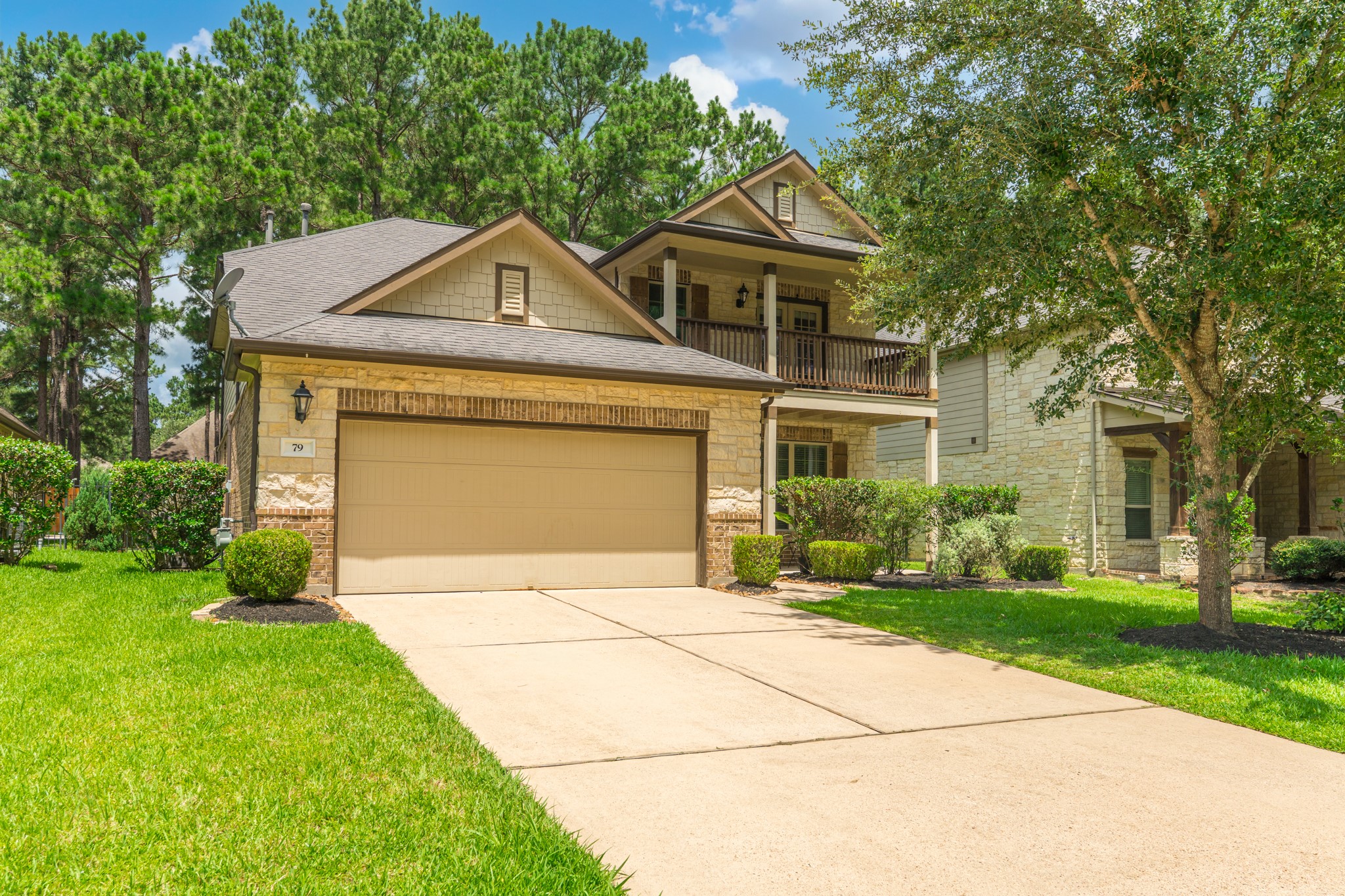 79 West Jagged Ridge Circle Spring, TX 77389 - Photo 1 of 50 This stunning two-story home welcomes you with warm tan and stone exterior finishes, a covered second-floor balcony, and a charming two-car garage. A long driveway and mature trees frame the lush green lawn, creating the kind of curb appeal that makes a lasting first impression on every visitor.