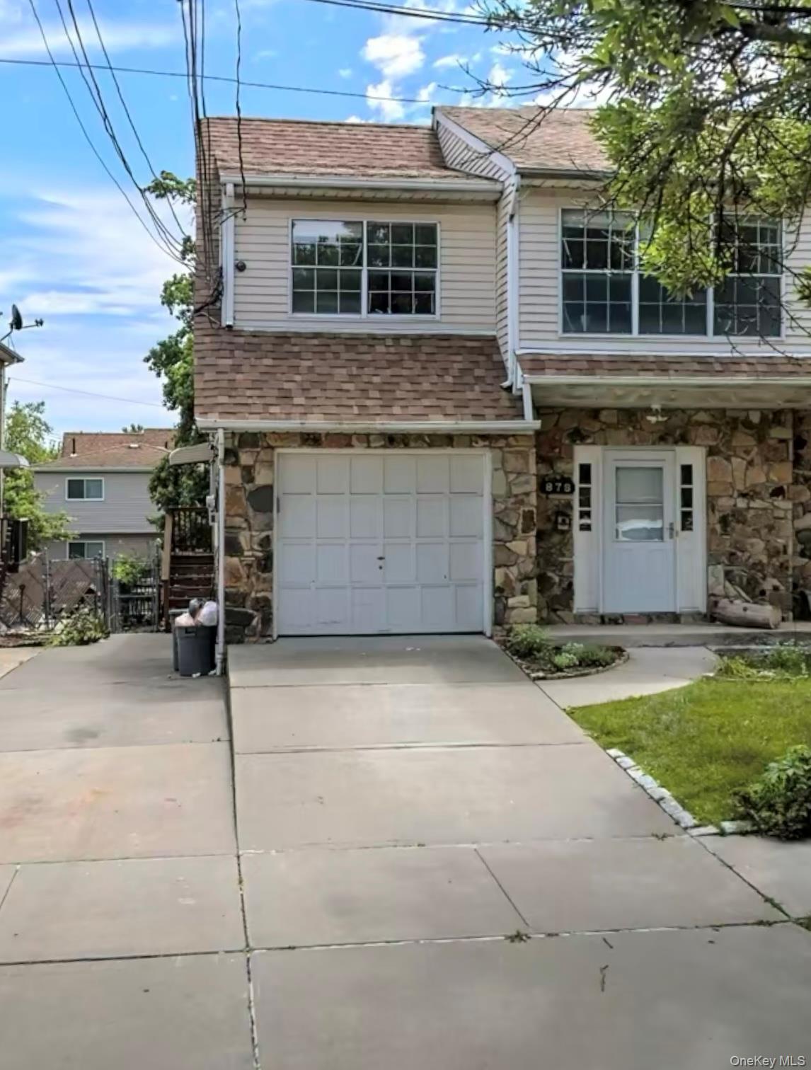 878 Rensselaer Avenue Staten Island, NY 10309 - Photo 1 of 35 Traditional-style house featuring stone siding, concrete driveway, a garage, and a shingled roof