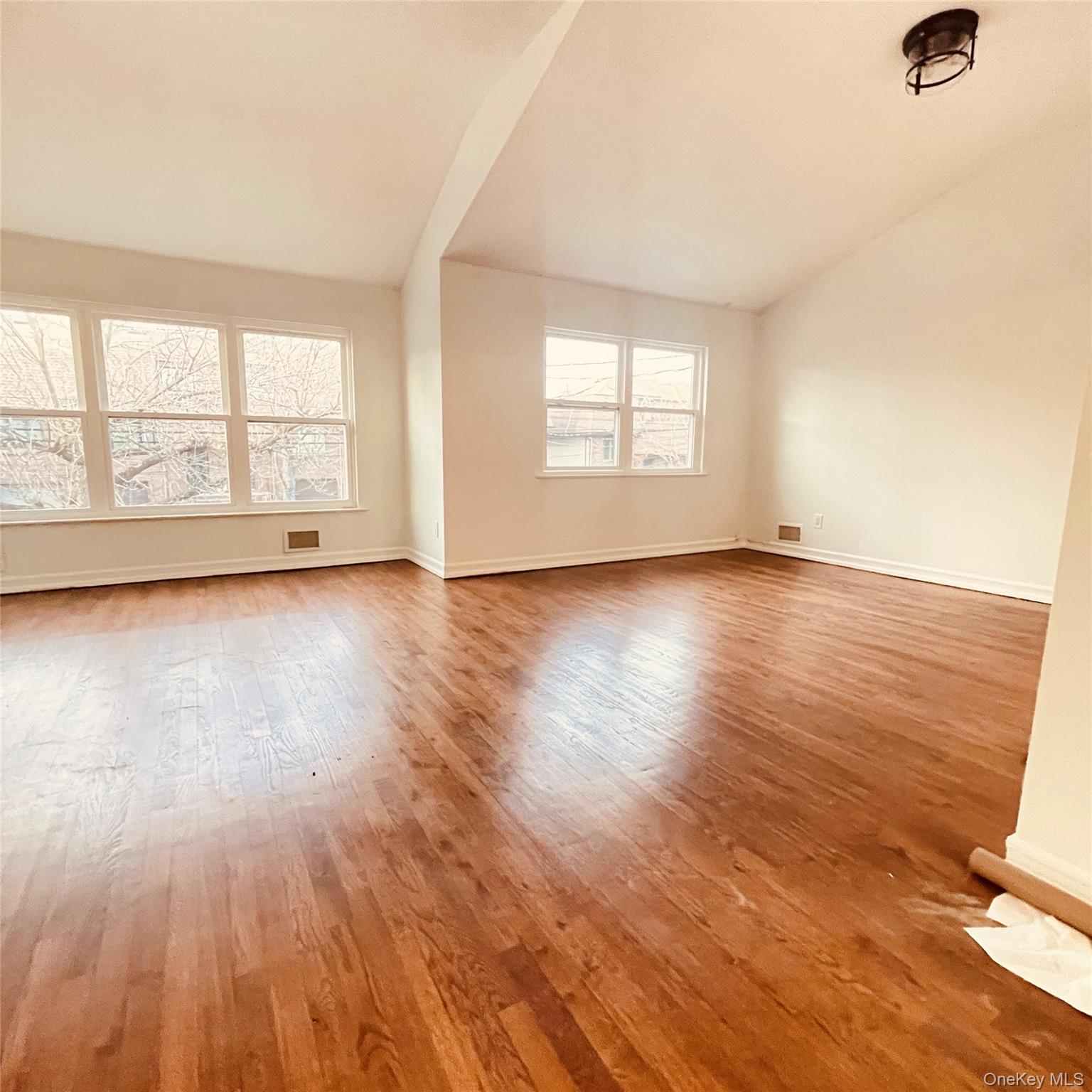 878 Rensselaer Avenue Staten Island, NY 10309 - Photo 14 of 35 Empty room featuring lofted ceiling and light wood-type flooring
