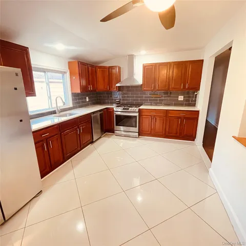 a kitchen with stainless steel appliances a refrigerator and wooden cabinets