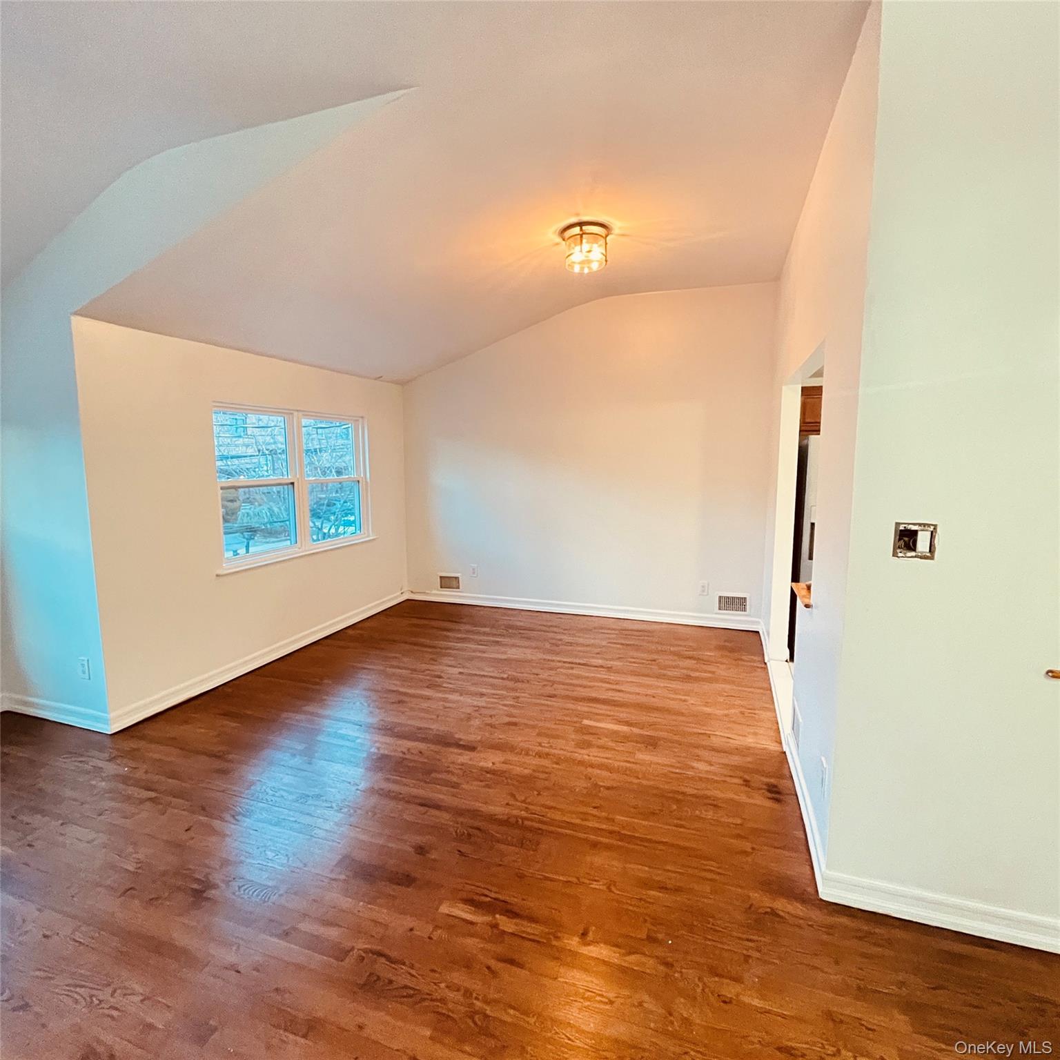 878 Rensselaer Avenue Staten Island, NY 10309 - Photo 21 of 35 Unfurnished room with lofted ceiling and dark wood-style floors