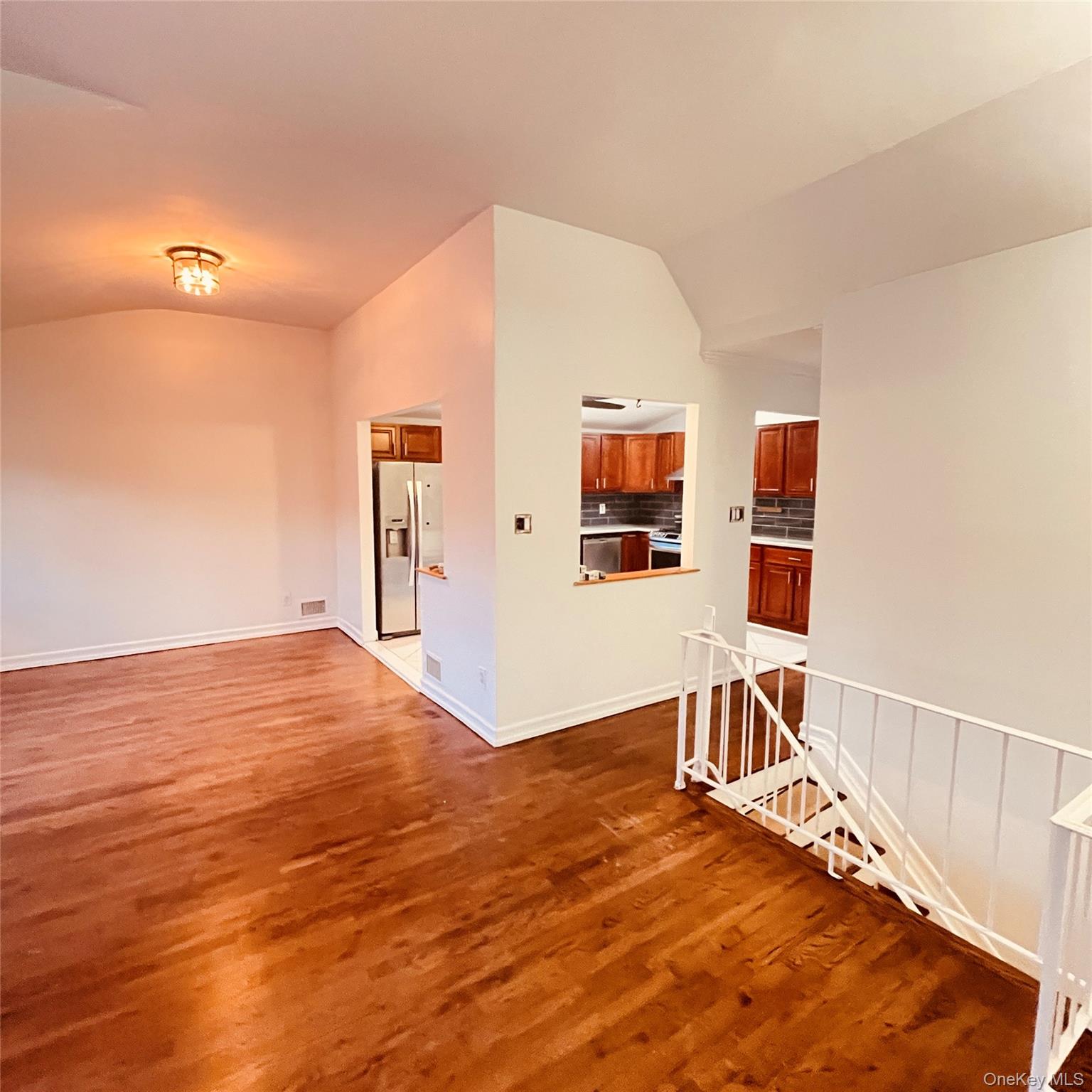 878 Rensselaer Avenue Staten Island, NY 10309 - Photo 24 of 35 Empty room with vaulted ceiling and dark wood-style floors