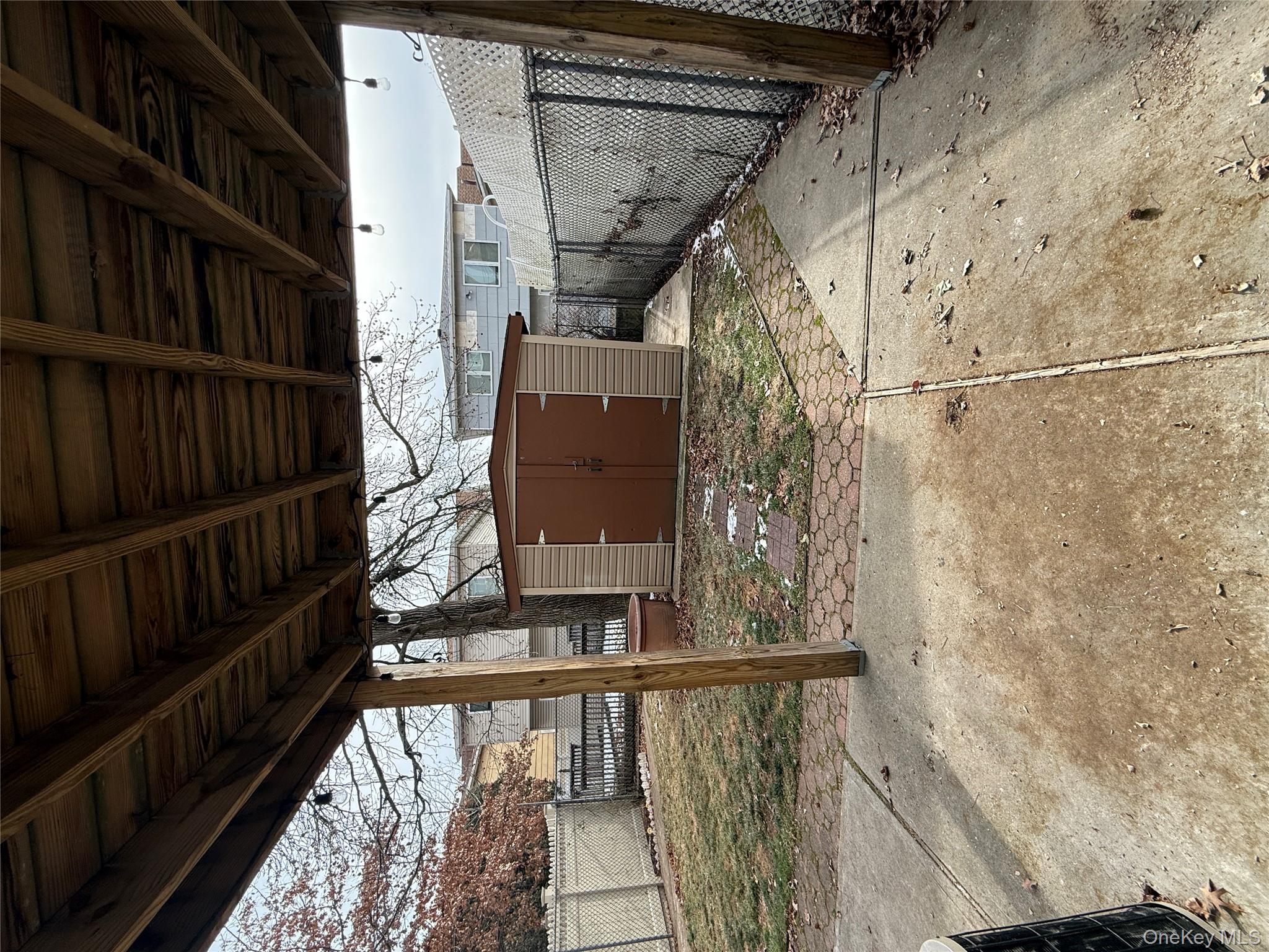 878 Rensselaer Avenue Staten Island, NY 10309 - Photo 29 of 35 Fenced backyard featuring a shed and a patio