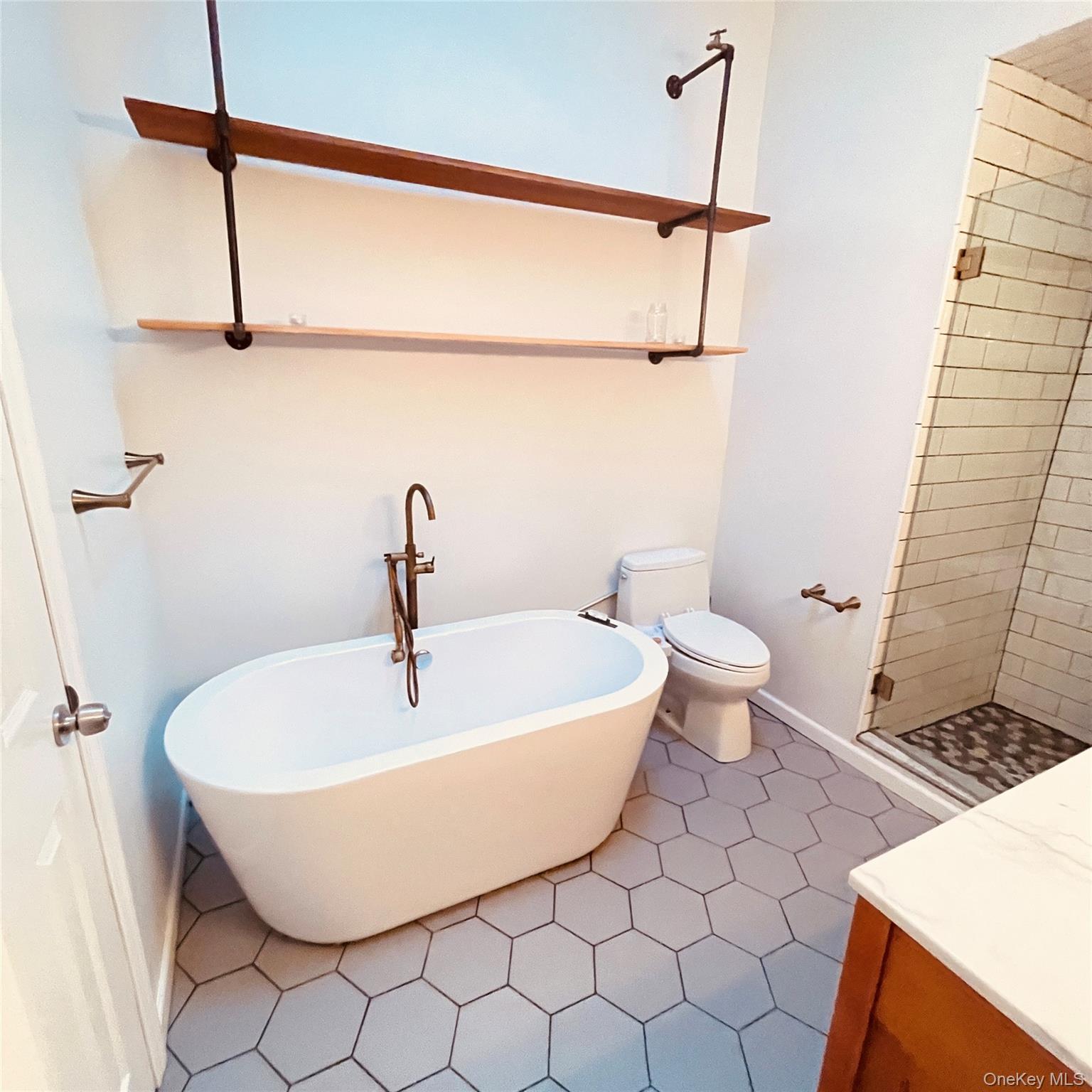 878 Rensselaer Avenue Staten Island, NY 10309 - Photo 8 of 35 Full bath featuring a soaking tub, a shower stall, and dark tile patterned floors