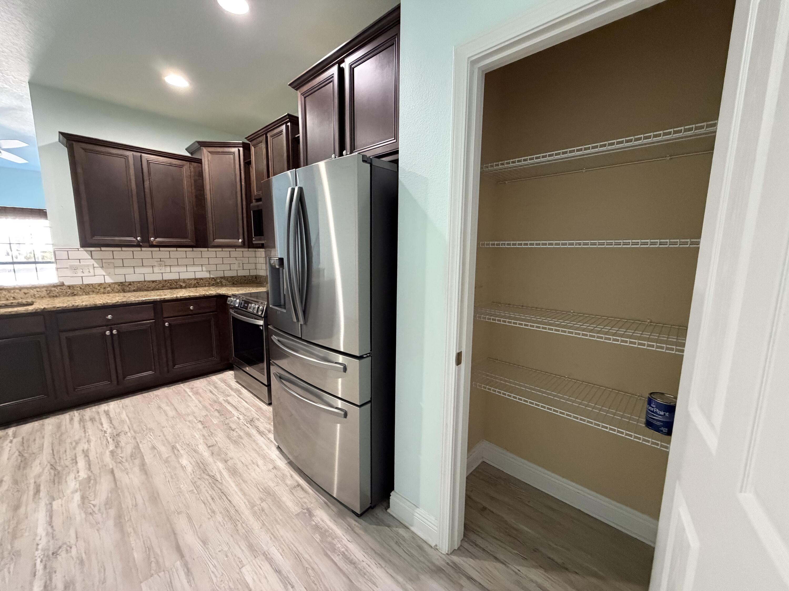 114 Rearden Way Santa Rosa Beach, FL 32459 - Photo 11 of 25 a kitchen with granite countertop stainless steel appliances and refrigerator