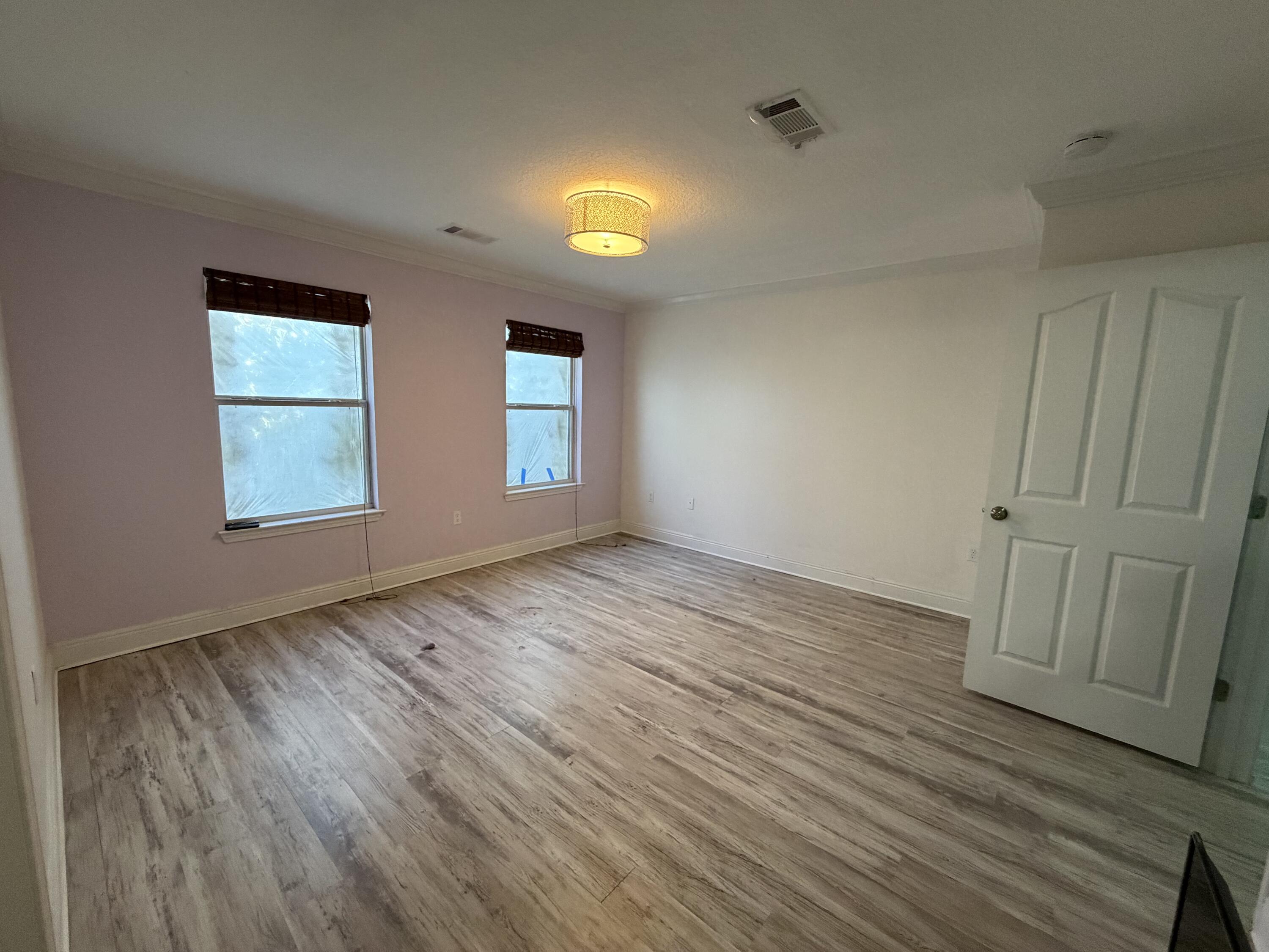 114 Rearden Way Santa Rosa Beach, FL 32459 - Photo 13 of 25 an empty room with wooden floor and windows