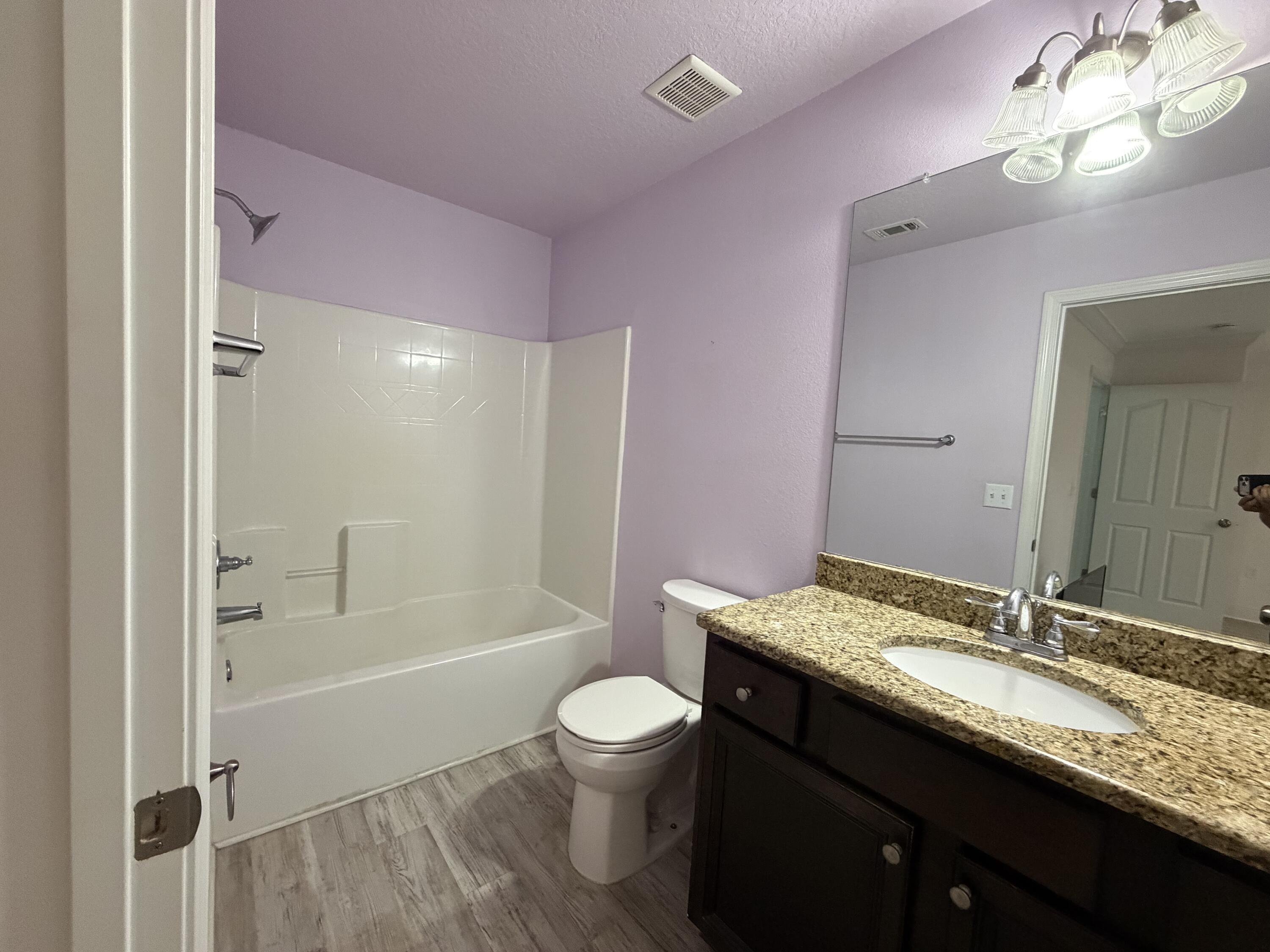 114 Rearden Way Santa Rosa Beach, FL 32459 - Photo 15 of 25 a bathroom with a granite countertop sink a toilet a mirror and shower