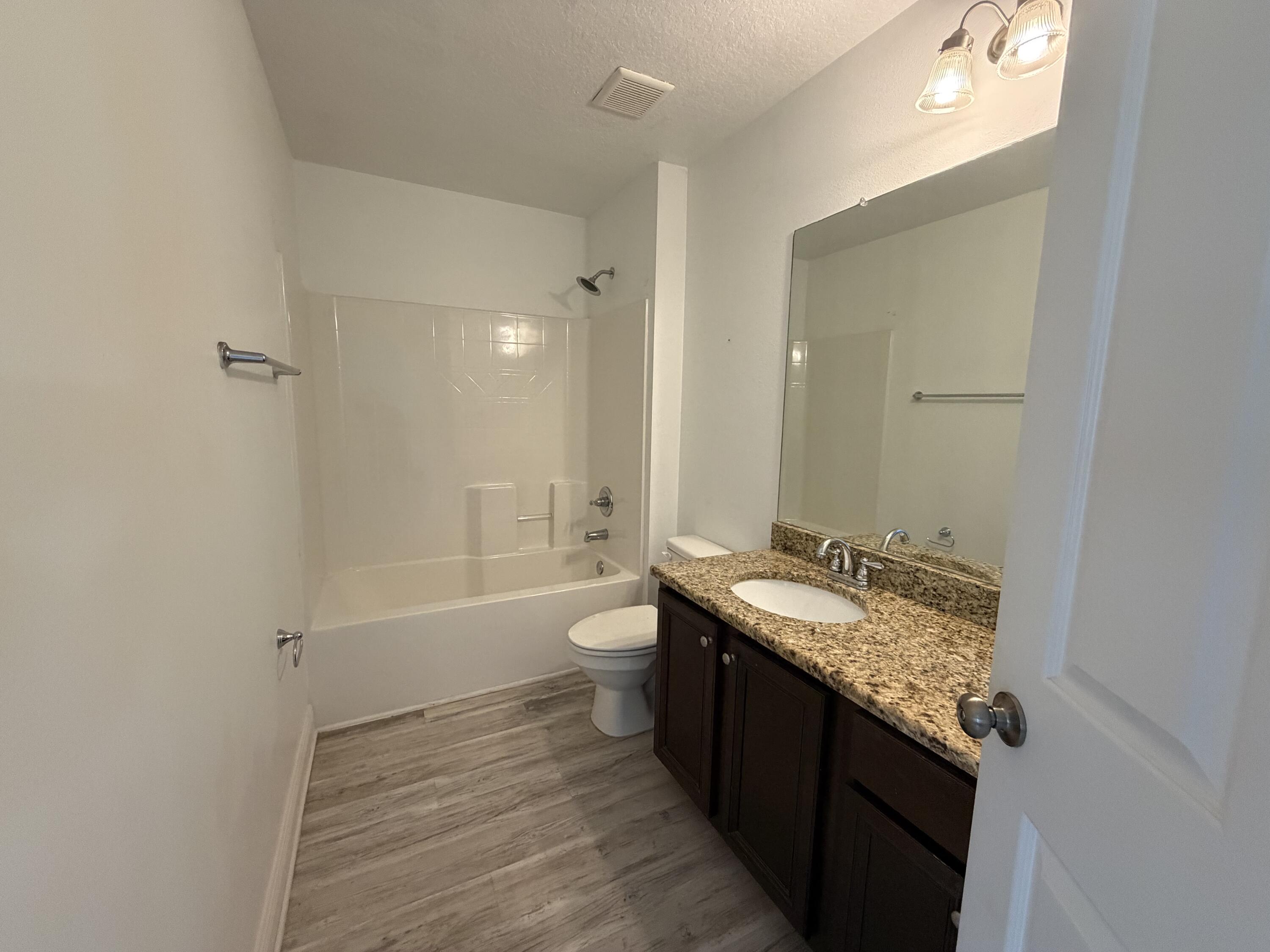 114 Rearden Way Santa Rosa Beach, FL 32459 - Photo 19 of 25 a bathroom with a granite countertop sink a toilet and shower