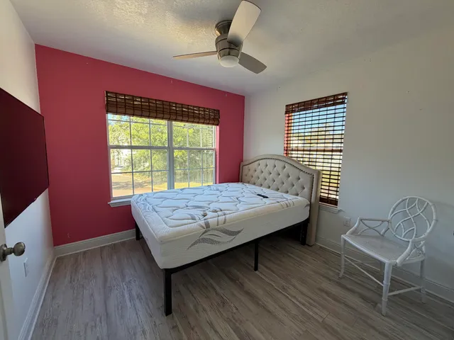 a bed sitting in a bedroom next to a window