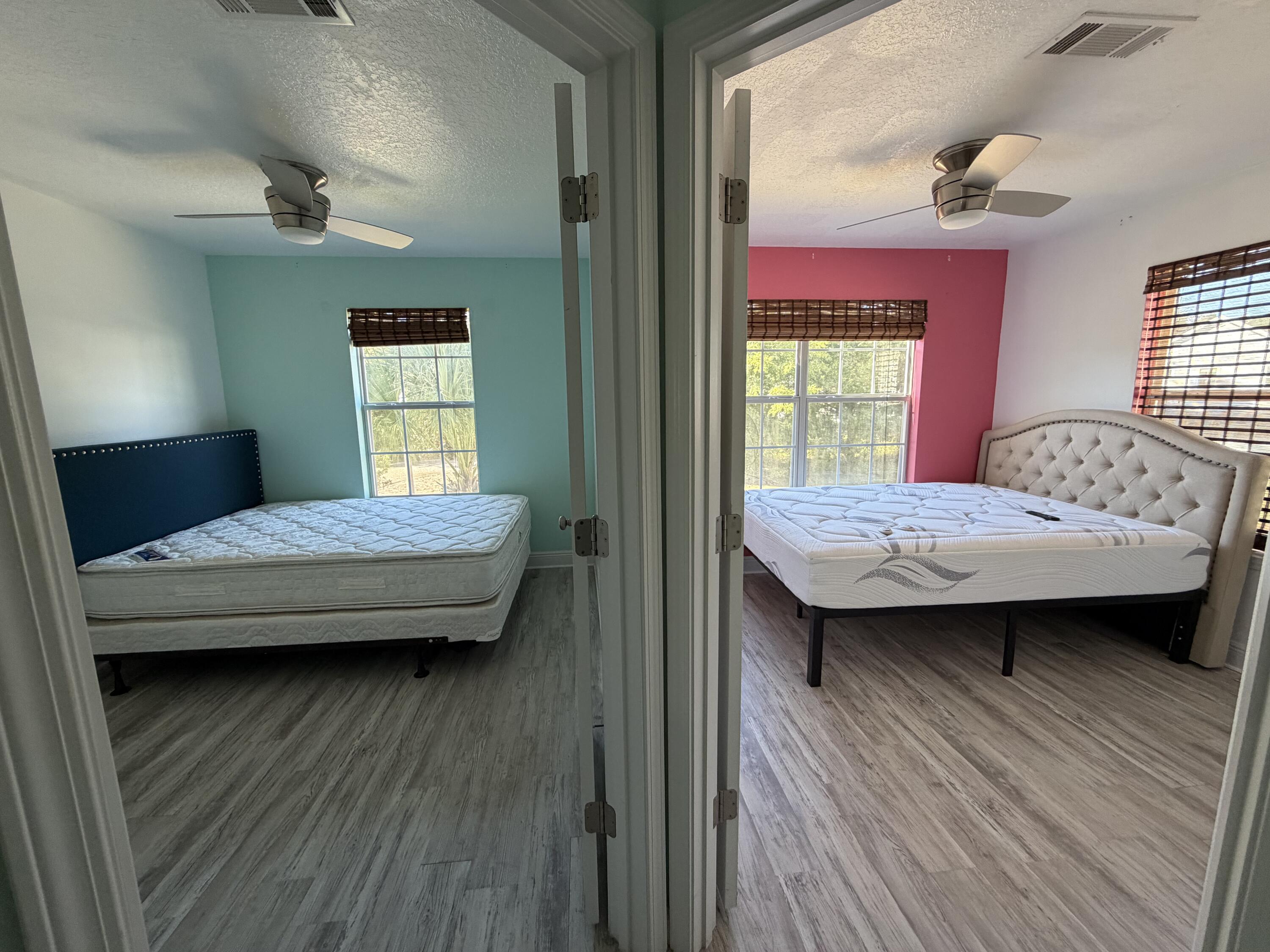 114 Rearden Way Santa Rosa Beach, FL 32459 - Photo 22 of 25 a bedroom with a bed wooden floor and window