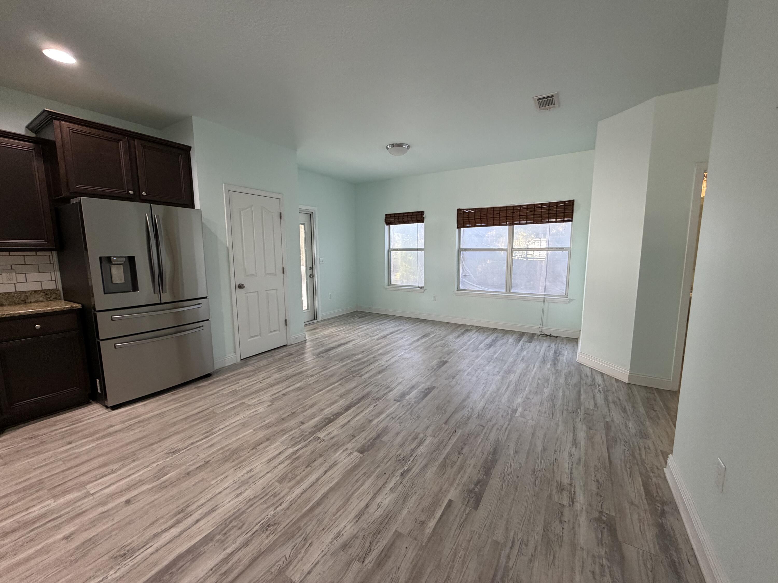 114 Rearden Way Santa Rosa Beach, FL 32459 - Photo 7 of 25 a view of a kitchen with wooden floor electronic appliances and window