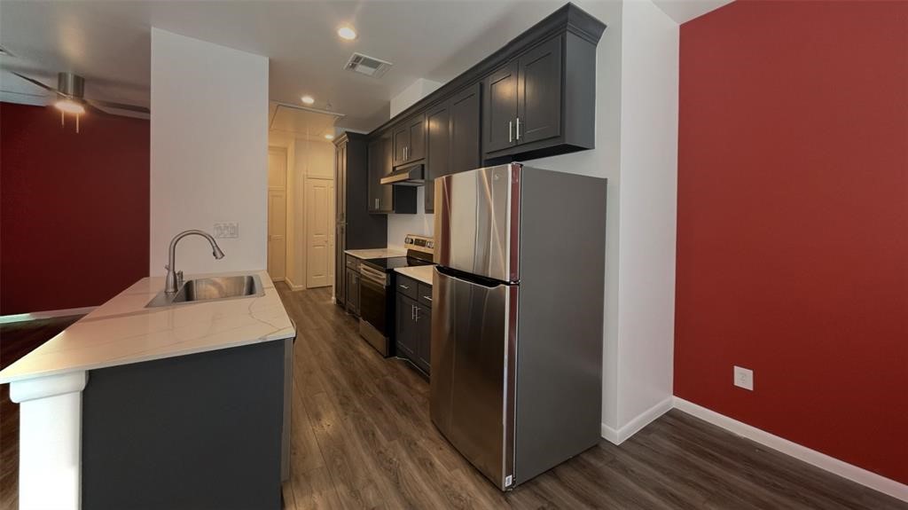 1920 Calumet Street, Unit 202 Houston, TX 77004 - Photo 2 of 7 a kitchen with stainless steel appliances a refrigerator sink and stove