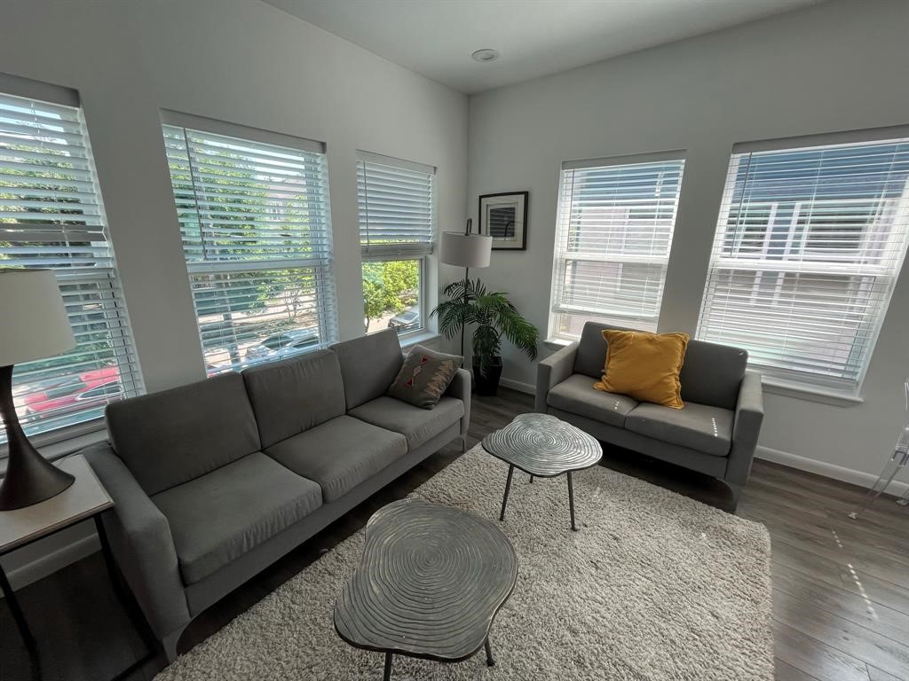 1920 Calumet Street, Unit 202 Houston, TX 77004 - Photo 3 of 7 a living room with furniture and a large window