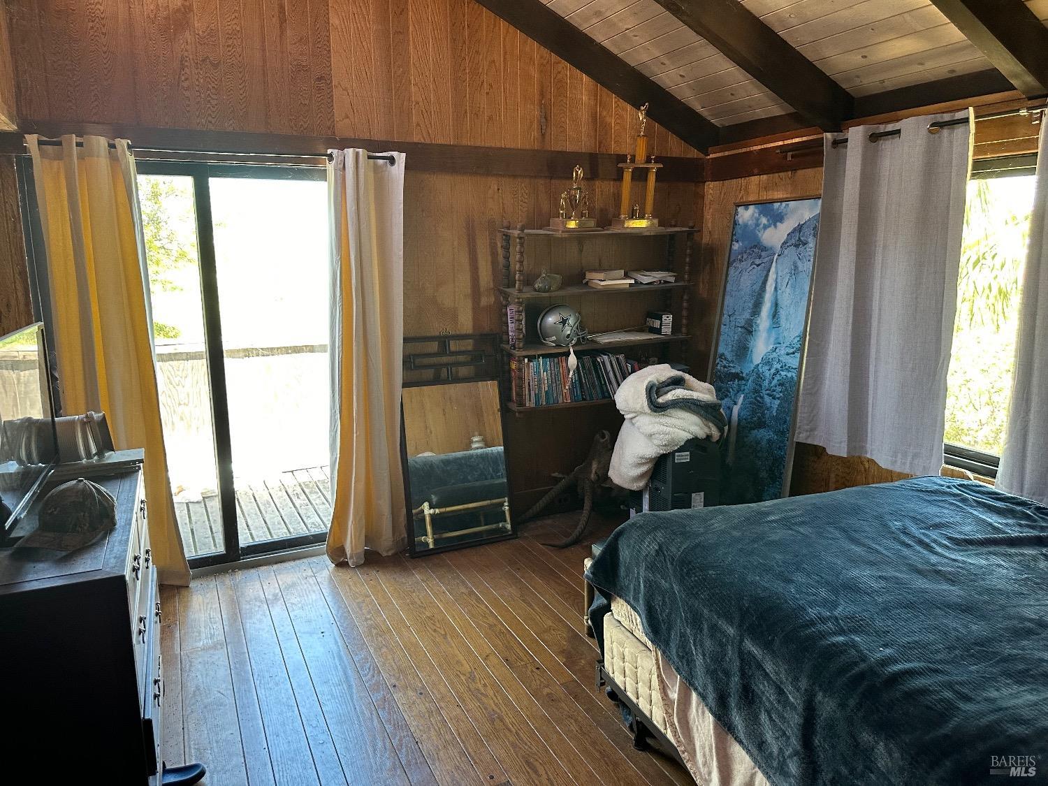 1 Pierce Lane Benicia, CA 94510 - Photo 12 of 25 a bedroom with a bed next to a window with wooden floor
