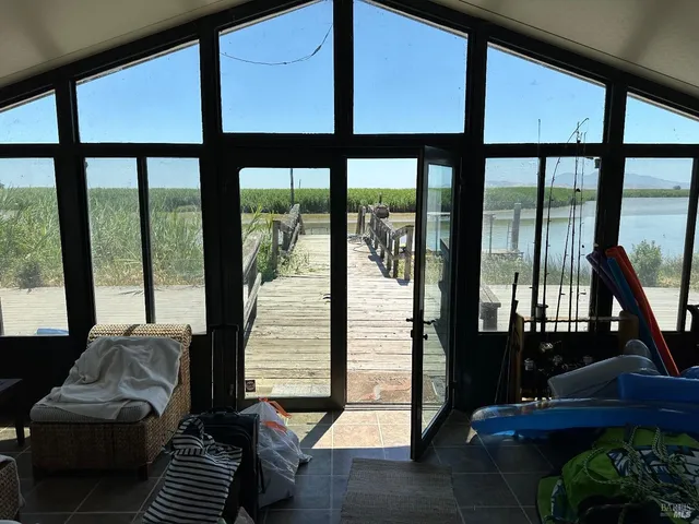 a living room with furniture and a floor to ceiling window