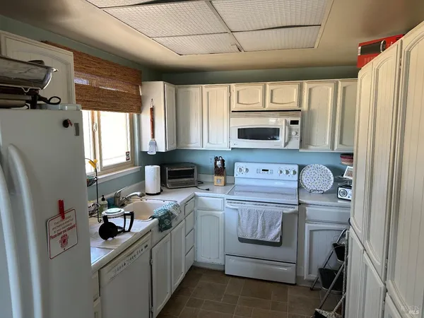 a kitchen with stainless steel appliances a stove microwave and a refrigerator