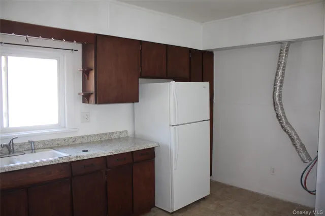 a white refrigerator freezer sitting inside of a kitchen