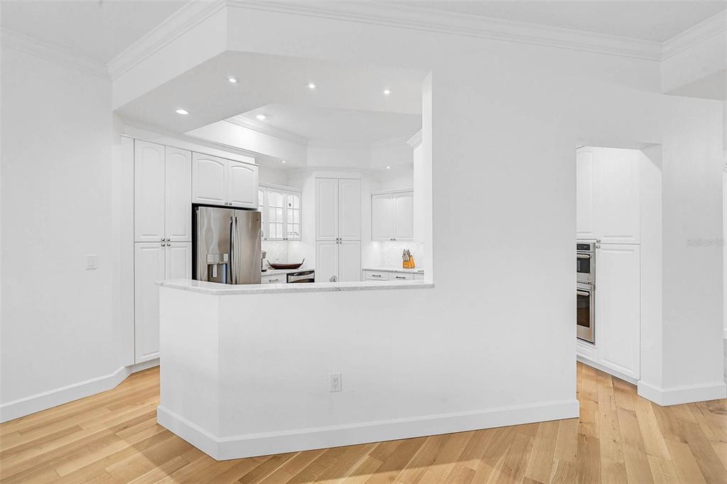 409 North Point Road, Unit 802 Osprey, FL 34229 - Photo 12 of 38 a view of kitchen with stainless steel appliances granite countertop a refrigerator a sink dishwasher and a stove with wooden floor