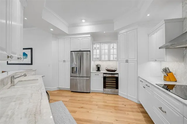 a kitchen with a refrigerator and a sink