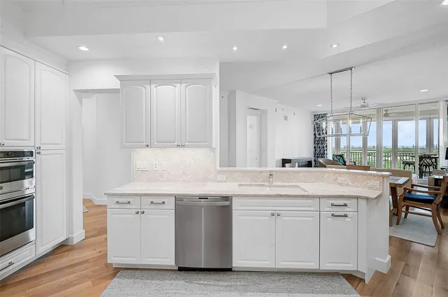 a kitchen with a stove a sink and a refrigerator