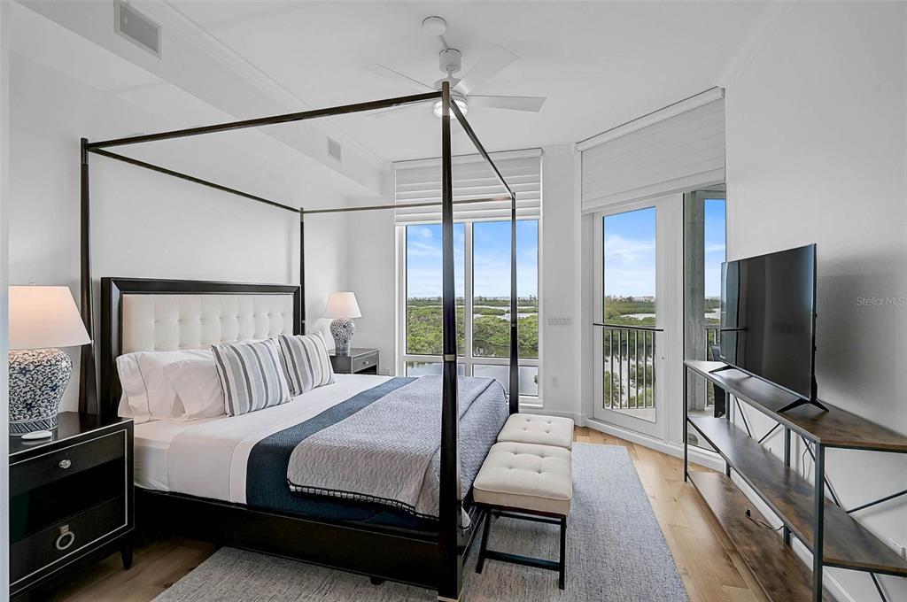 409 North Point Road, Unit 802 Osprey, FL 34229 - Photo 17 of 38 a bedroom with a bed and a flat screen tv