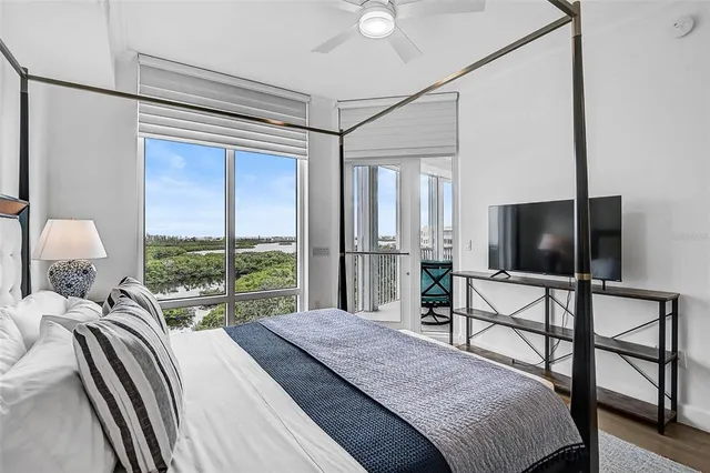 a bedroom with a bed and a flat tv screen on dresser